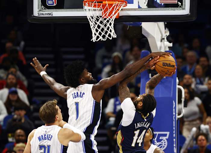 Magic's Jonathan Isaac blocks Pelican's Brandon Ingram.